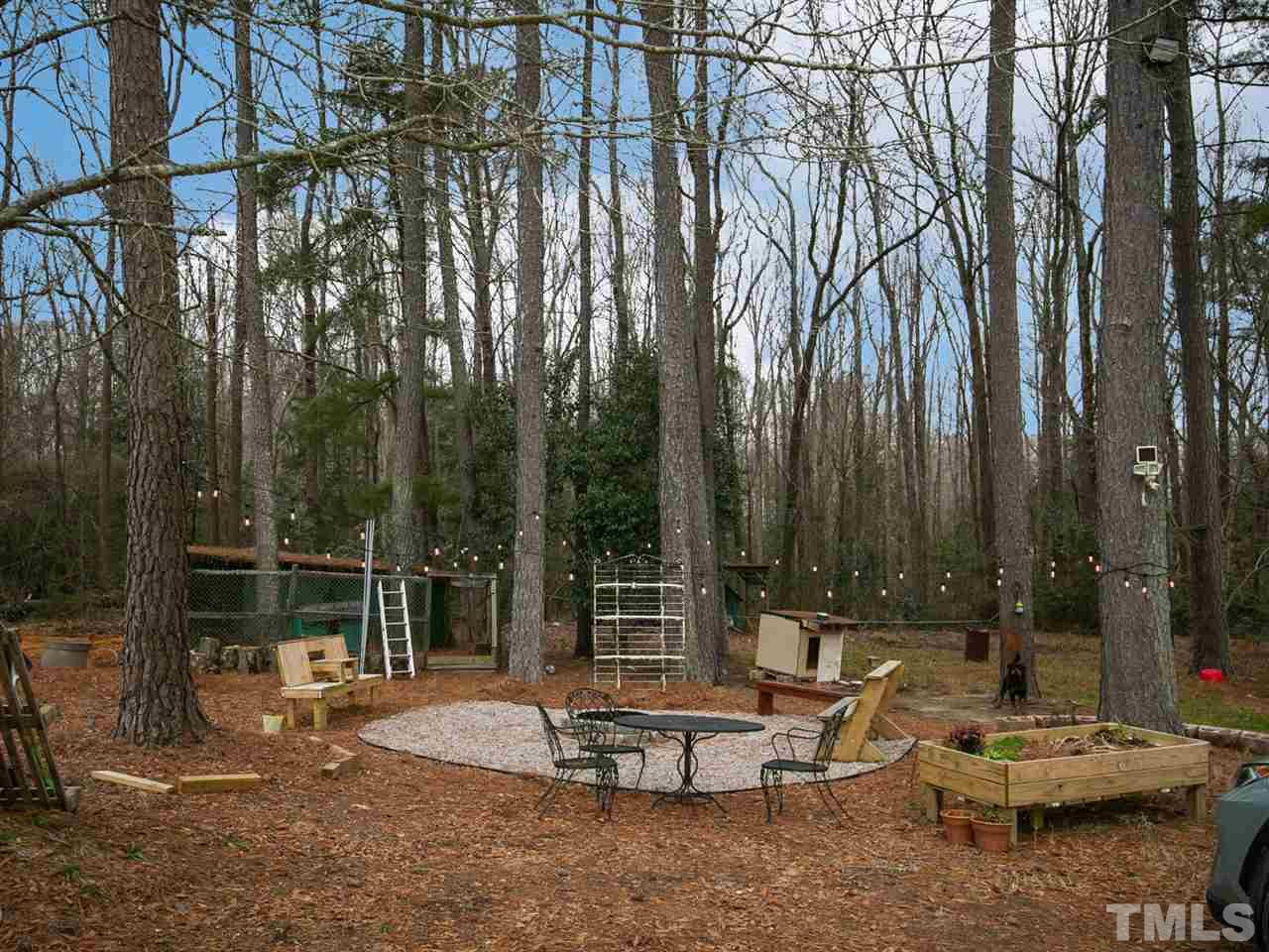 7532 Martin Road Zebulon, NC 27597 - Photo 25 of 26 a view of a patio with a table chairs and a fire pit
