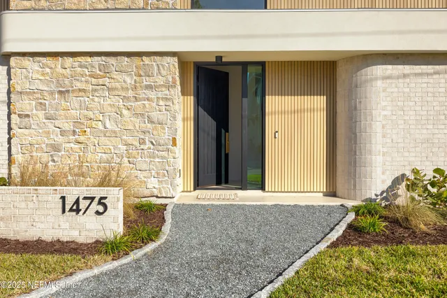 a living room with furniture a fireplace and a large window