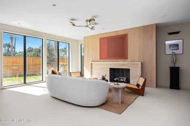 a kitchen with white cabinets and chairs