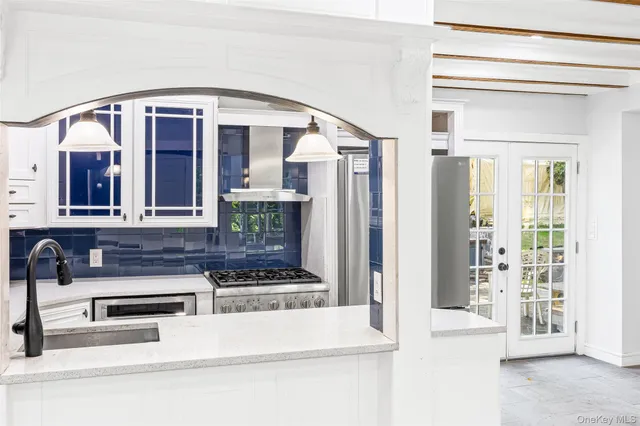 a view of a hallway with entryway and kitchen