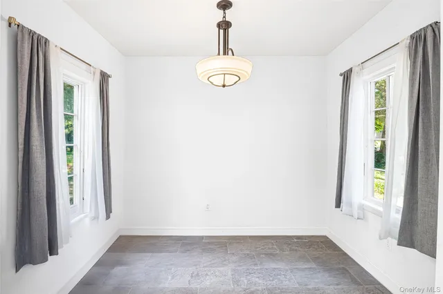 a view of a room with window and front door