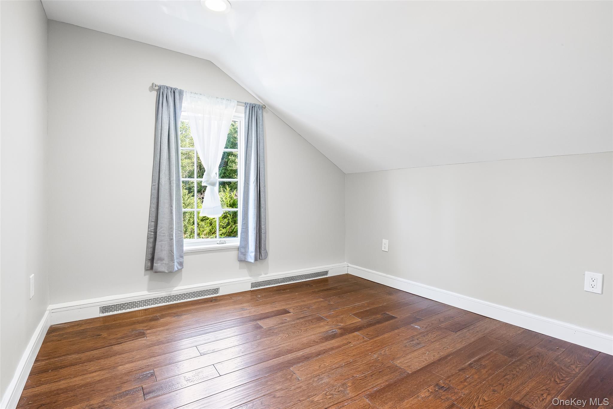143 Rocky Point Landing Road Rocky Point, NY 11778 - Photo 18 of 43 an empty room with wooden floor and windows