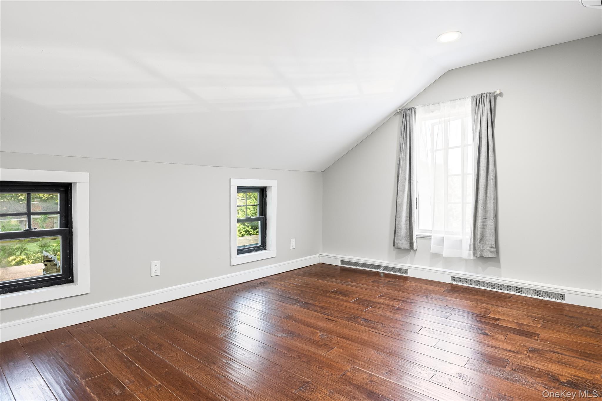 143 Rocky Point Landing Road Rocky Point, NY 11778 - Photo 21 of 43 an empty room with wooden floor and windows