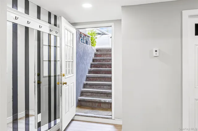 a view of a hallway with wooden floor and entryway
