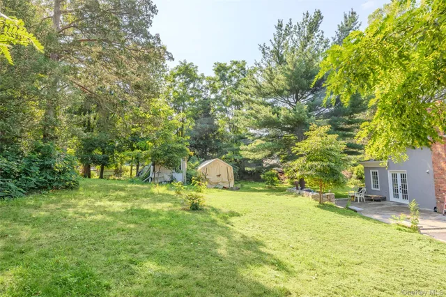 a view of a house with swimming pool and sitting area