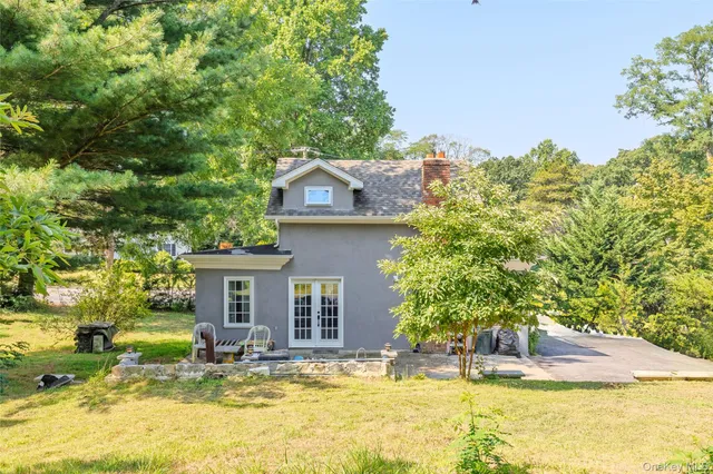 a view of a house with backyard porch and sitting area