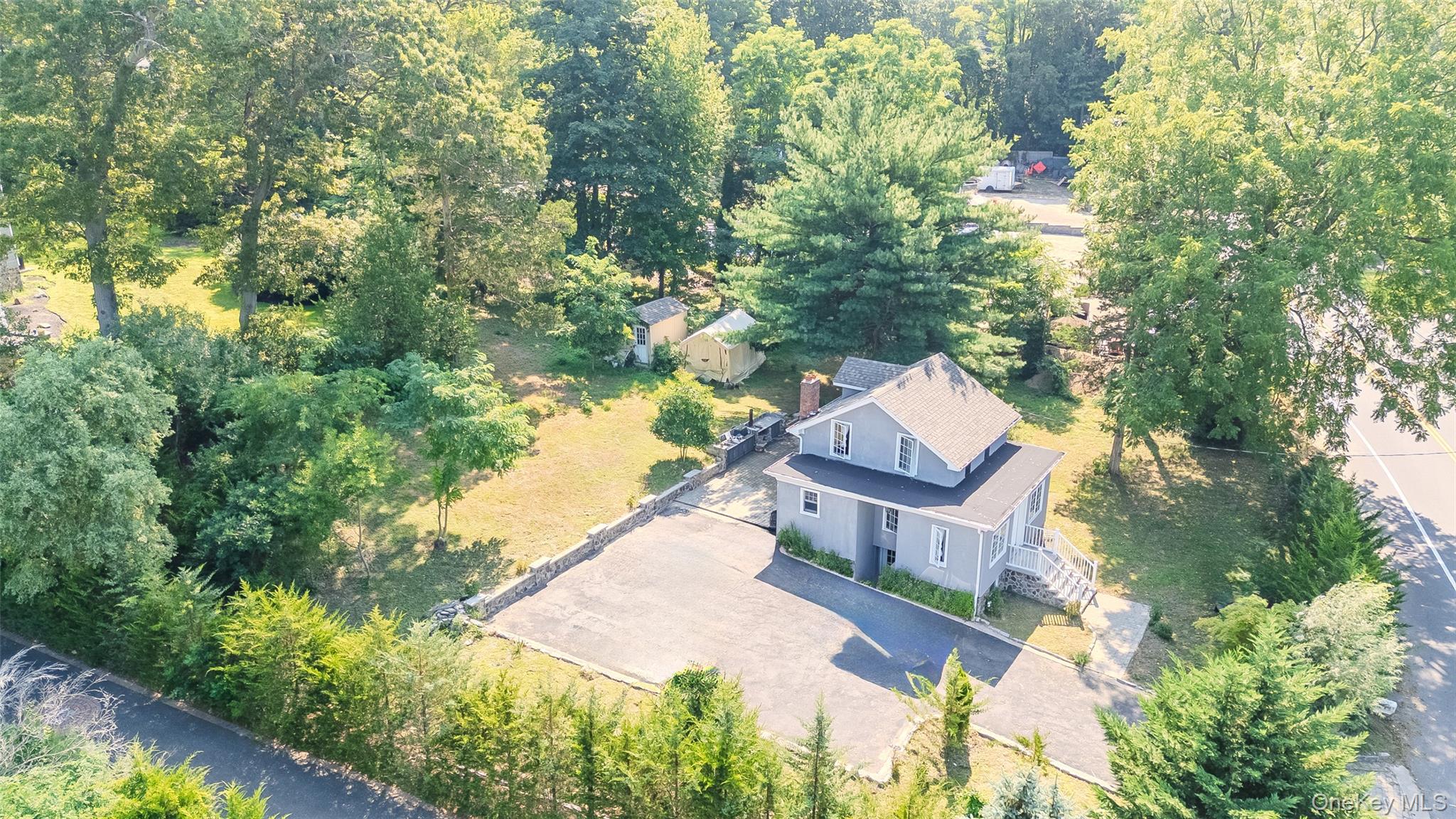 143 Rocky Point Landing Road Rocky Point, NY 11778 - Photo 32 of 43 an aerial view of a house with a yard and large trees