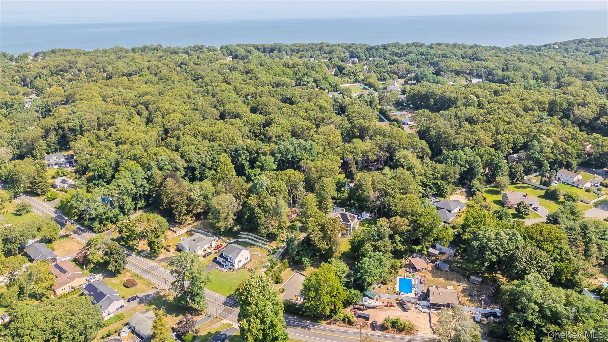 143 Rocky Point Landing Road Rocky Point, NY 11778 - Photo 36 of 43 a view of a green field with lots of bushes
