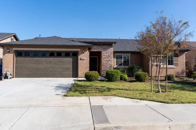 a front view of a house with a yard