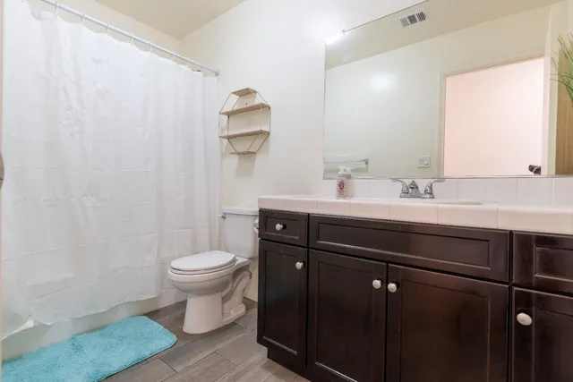 a bathroom with a sink toilet and mirror