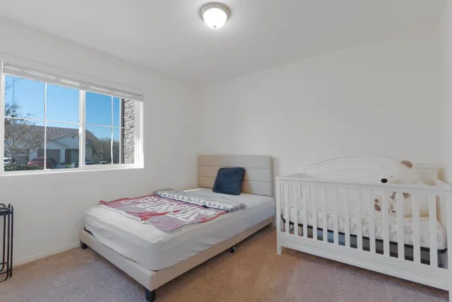 a bedroom with a bed and window
