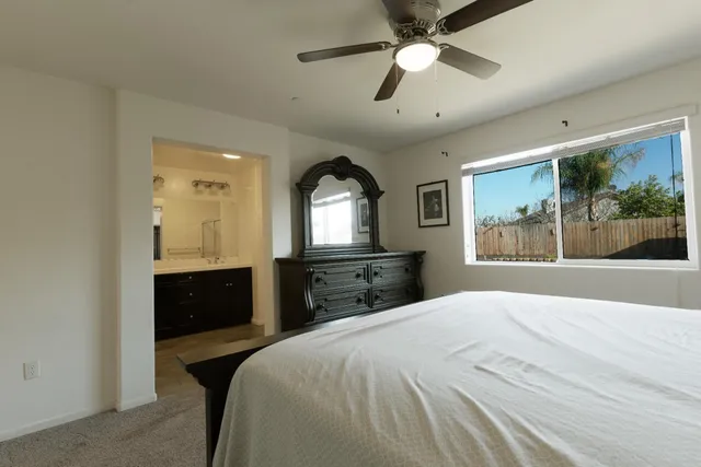 a bedroom with a large bed and a large window