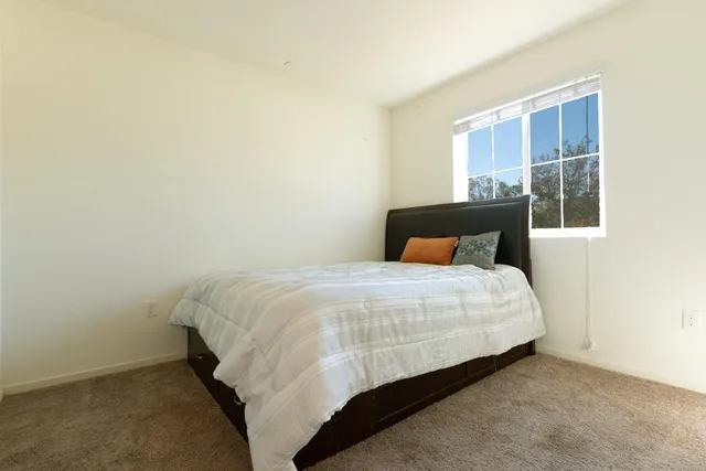 a bedroom with a bed and window