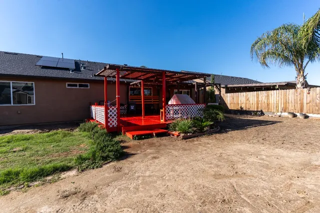 a view of a chair and table in backyard