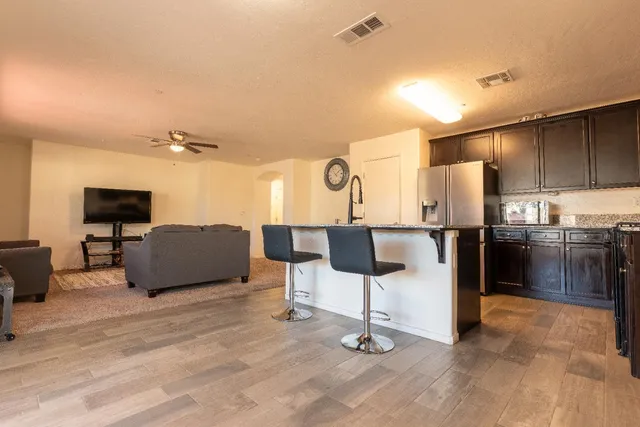 a kitchen with stainless steel appliances kitchen island a refrigerator and a stove top oven