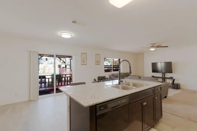 a kitchen with a sink a counter space and dining room