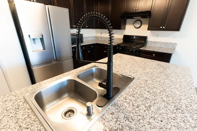 a kitchen with a refrigerator and a sink