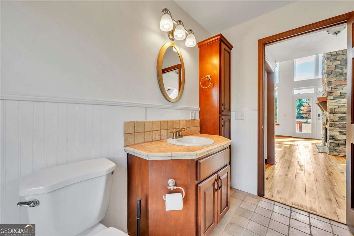 11157 Cannonville Road Rochelle, GA 31079 - Photo 17 of 38 a bathroom with a sink a toilet and a mirror