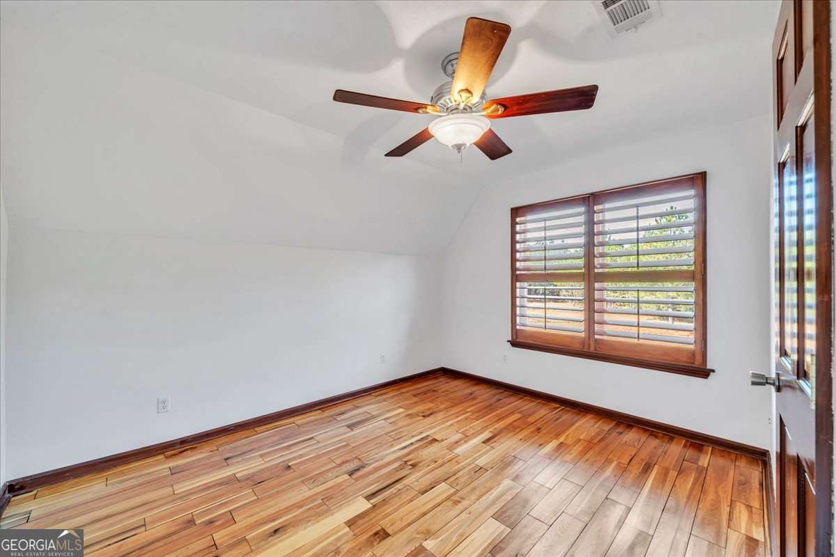 11157 Cannonville Road Rochelle, GA 31079 - Photo 20 of 38 a view of empty room with wooden floor and fan