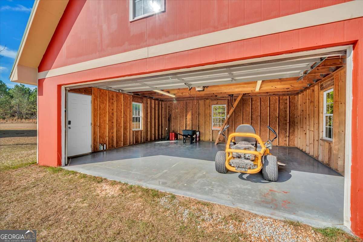 11157 Cannonville Road Rochelle, GA 31079 - Photo 26 of 38 a view of a room with wooden floor and gym equipment