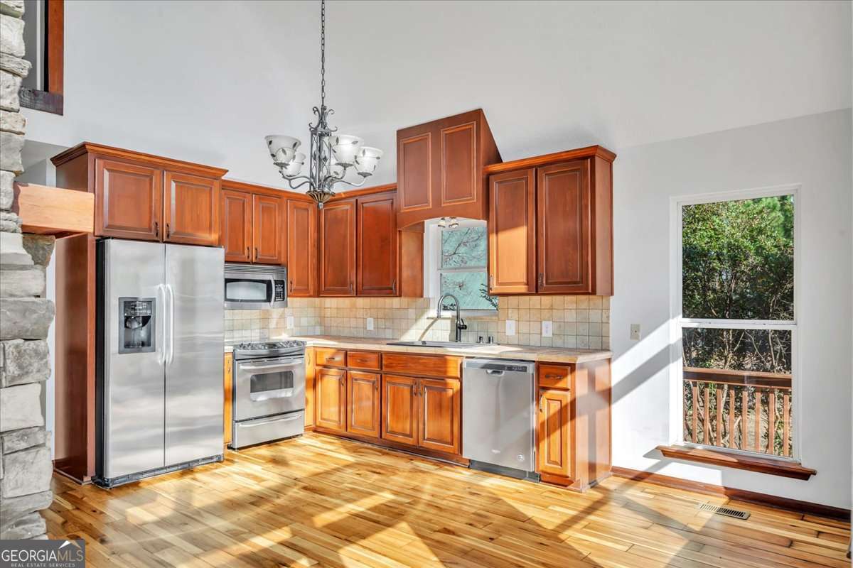 11157 Cannonville Road Rochelle, GA 31079 - Photo 3 of 38 a kitchen with stainless steel appliances granite countertop a stove top oven a refrigerator and a sink