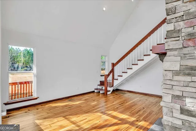 a view of entryway and hall with wooden floor