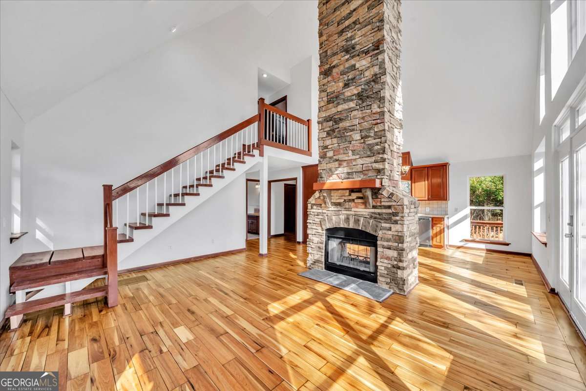 11157 Cannonville Road Rochelle, GA 31079 - Photo 9 of 38 a view of a livingroom with a fireplace wooden floor and staircase