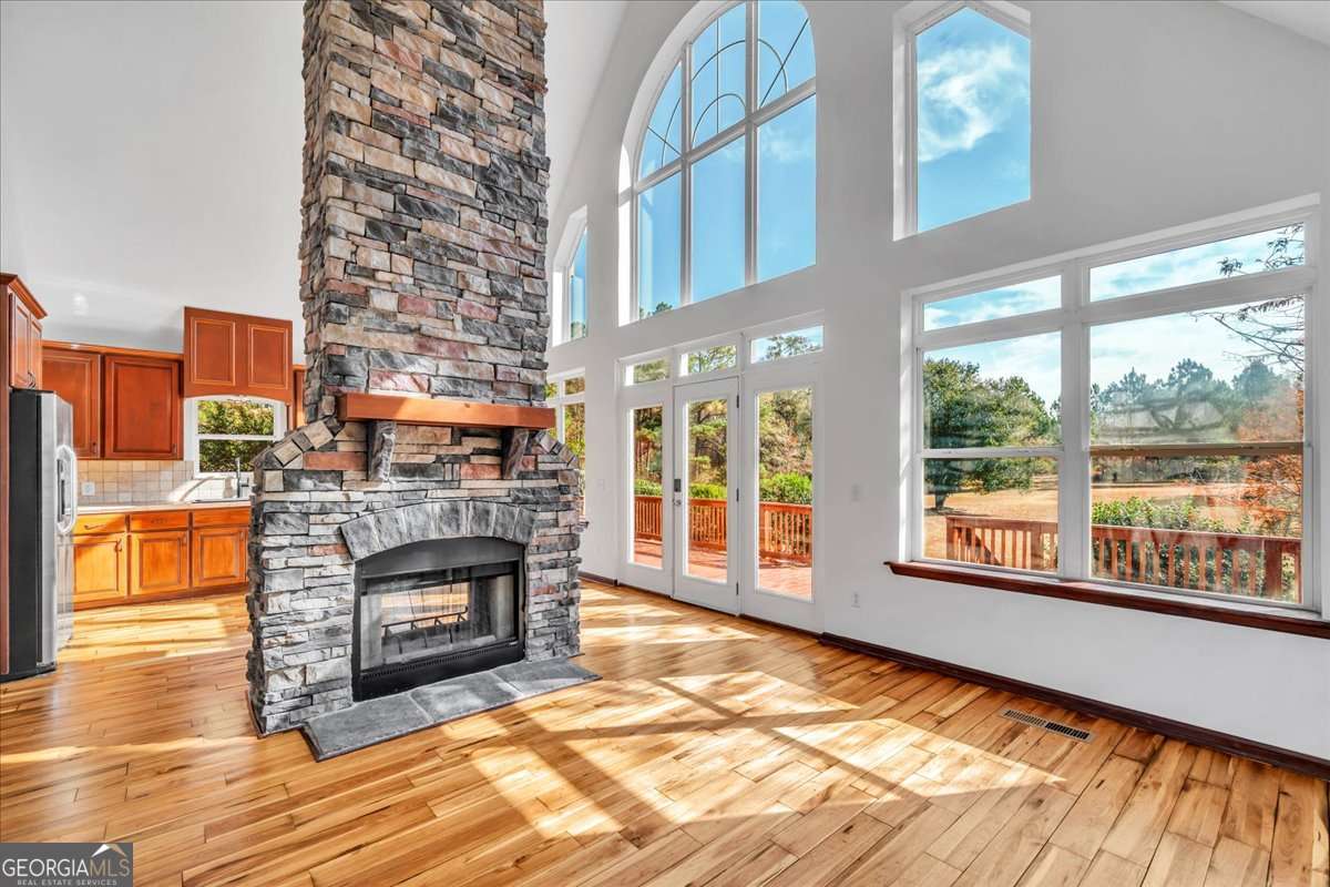 11157 Cannonville Road Rochelle, GA 31079 - Photo 10 of 38 a living room with fireplace furniture and a floor to ceiling window