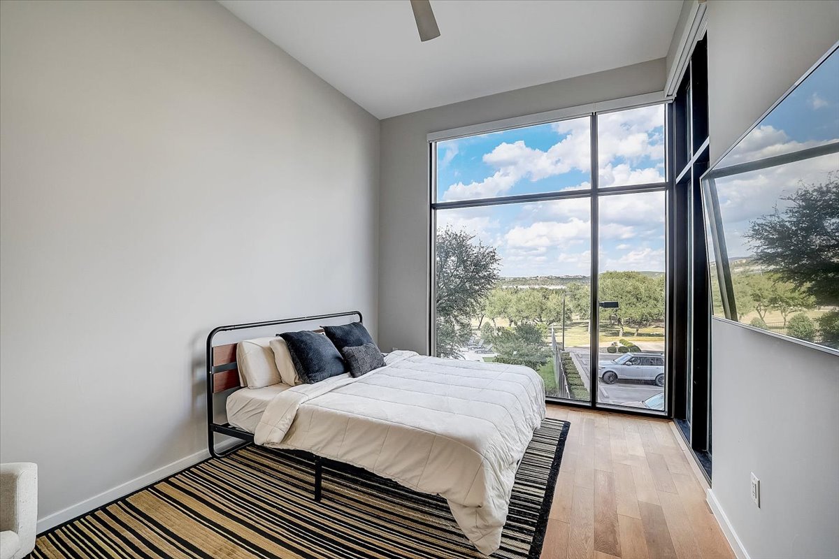 5921 Hiline Road, Unit 1204 Austin, TX 78734 - Photo 24 of 36 Bedroom featuring light wood-style flooring, ceiling fan, and access to outside