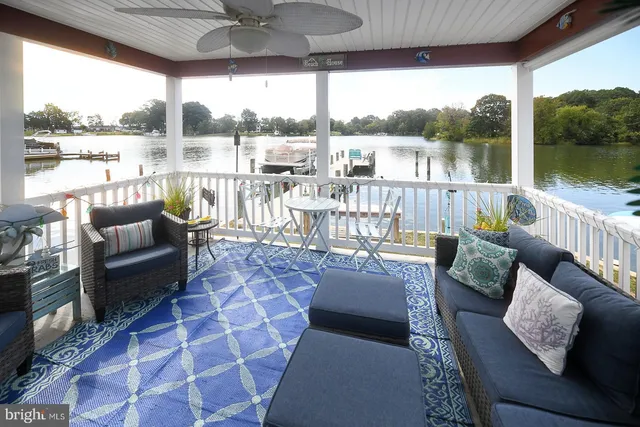a balcony with furniture and a floor to ceiling window