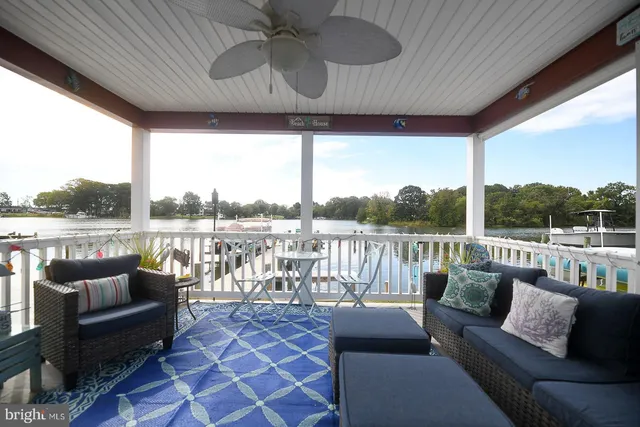 a balcony with furniture and a floor to ceiling window