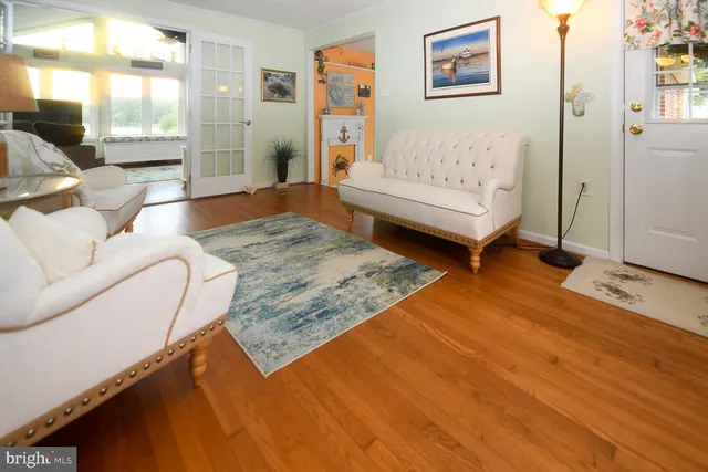 a living room with furniture rug and wooden floor