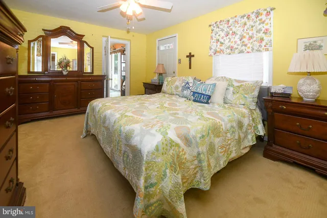 a bed sitting in a bedroom next to a window and dresser