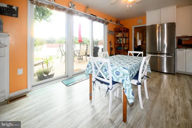 a view of a dining room with furniture large window and wooden floor