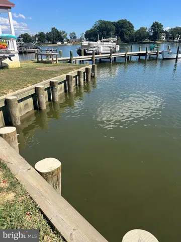 a view of a lake with lawn chairs