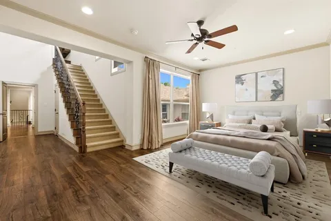 a spacious bedroom with a bed and a ceiling fan