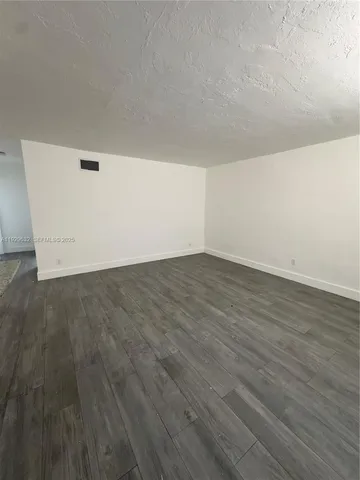 an empty room with wooden floor