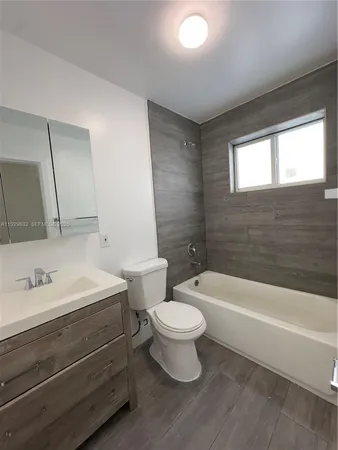 a bathroom with a sink a toilet and a bathtub