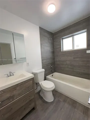 a bathroom with a sink a toilet and a bathtub