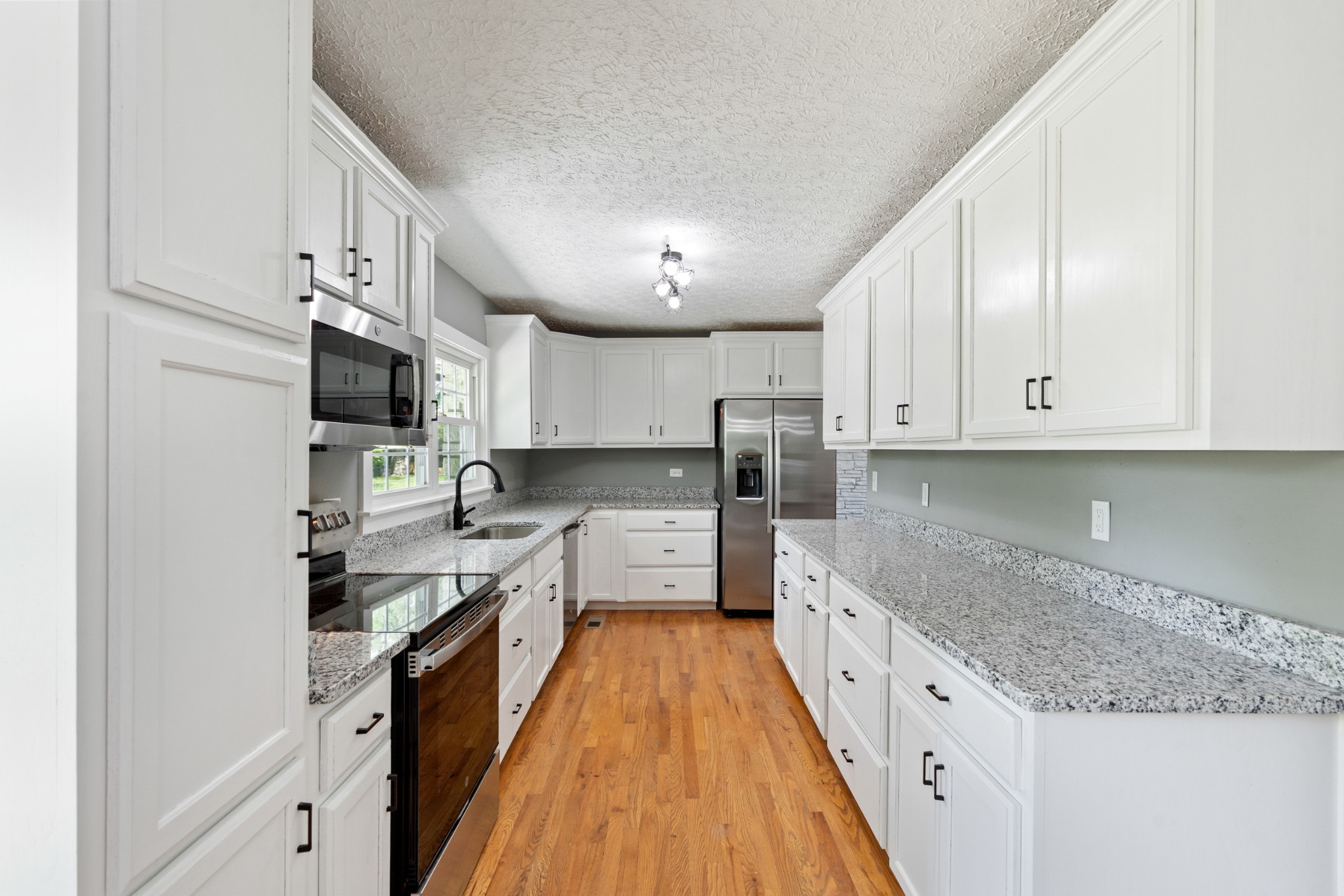 1503 5th Avenue West Springfield, TN 37172 - Photo 6 of 43 a large kitchen with stainless steel appliances granite countertop a lot of counter space and wooden floors