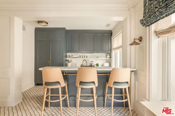 a dining room with wooden floor and white cabinet