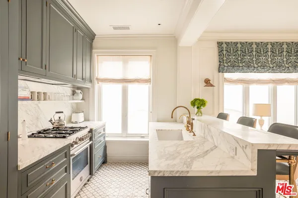a kitchen with a stove a sink and a refrigerator
