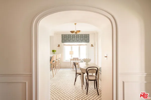 a view of a dining room with furniture and a window