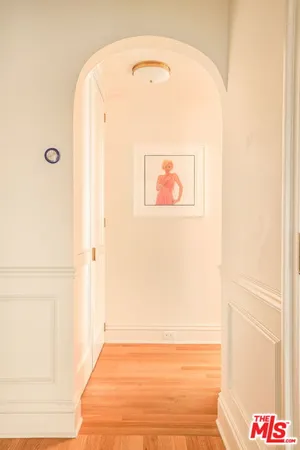 a spacious bedroom with a bed and a chandelier