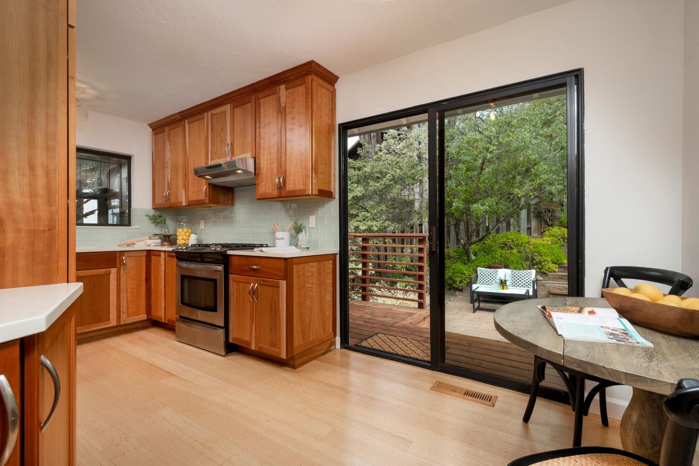 701 Canyon Drive Pacifica, CA 94044 - Photo 12 of 42 a open kitchen with granite countertop a stove a sink a dining table and chairs