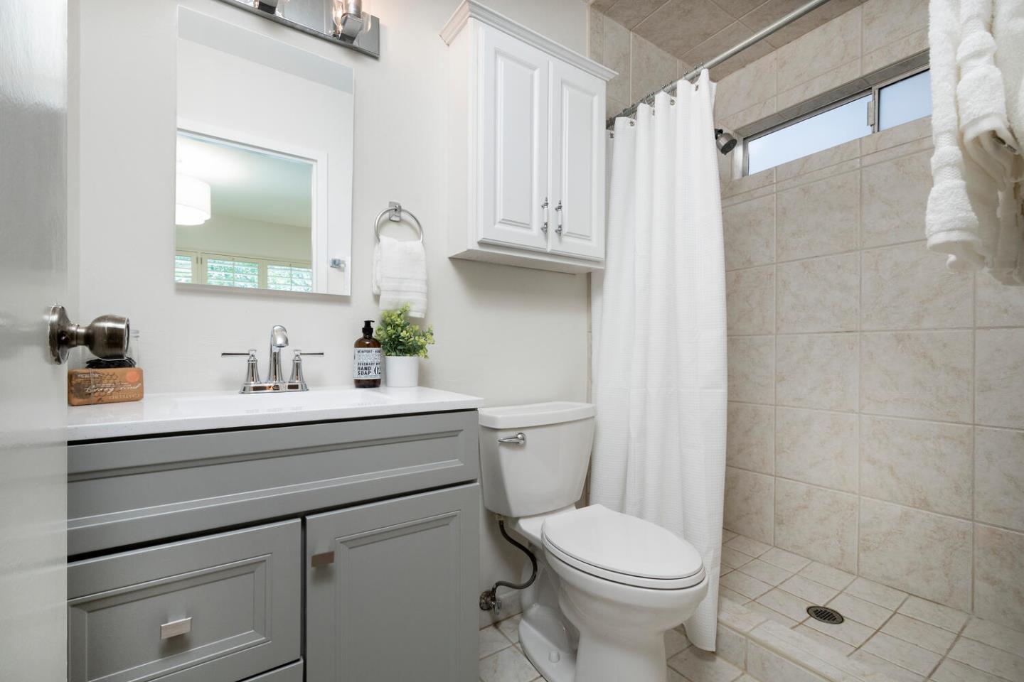 701 Canyon Drive Pacifica, CA 94044 - Photo 21 of 42 a bathroom with a sink a toilet and shower