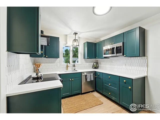 a kitchen with a sink cabinets and window