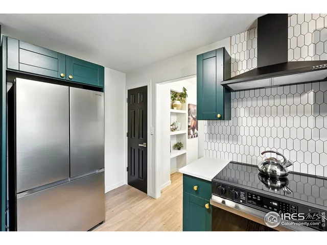 a kitchen with stainless steel appliances granite countertop a refrigerator and a stove