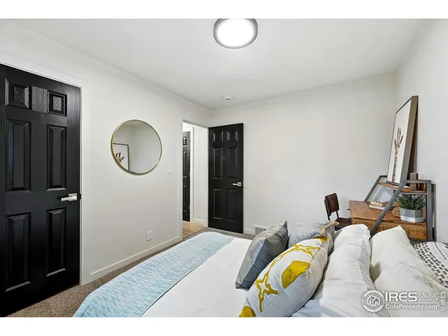 a bed room with a bed mirror and a window