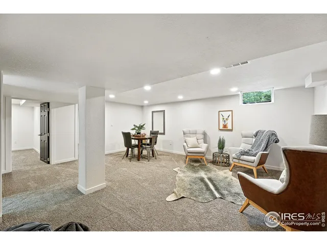 a living room with furniture a dining table and chairs